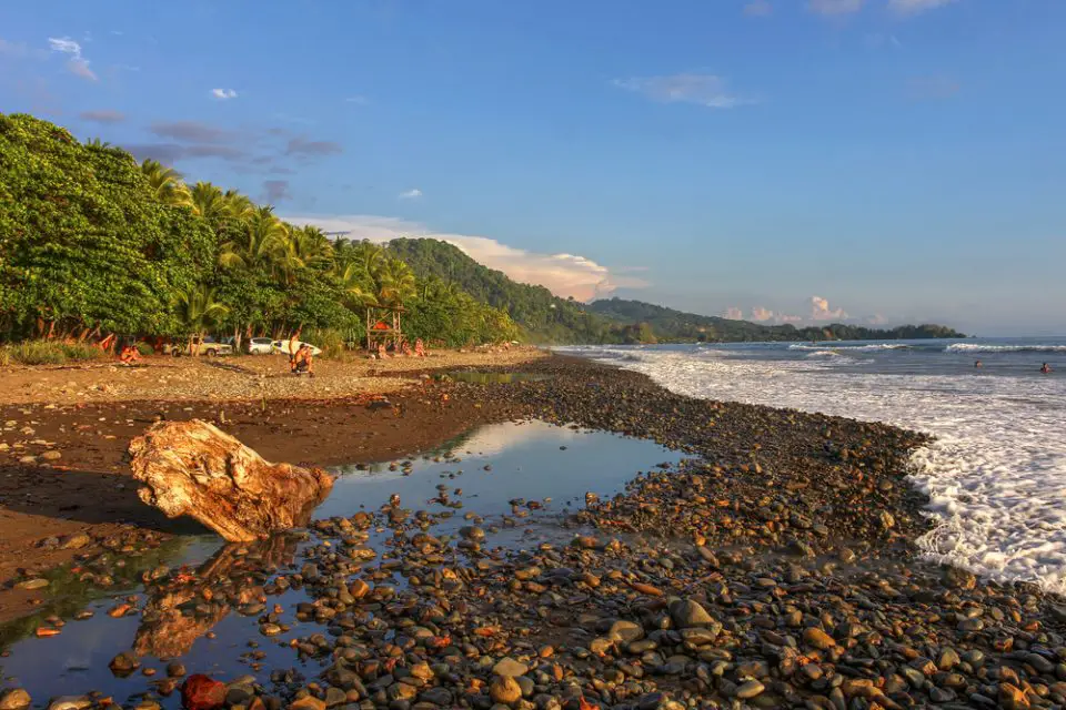 A surfer's destination, Playa Dominical in Costa Rica is a rocky beach settled mostly by foreign surfers.
