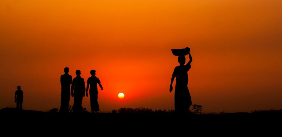 Five people are on the way home from work at sunset in Baikka Beel area, Srimangal, Moulvibazar, Bangladesh
