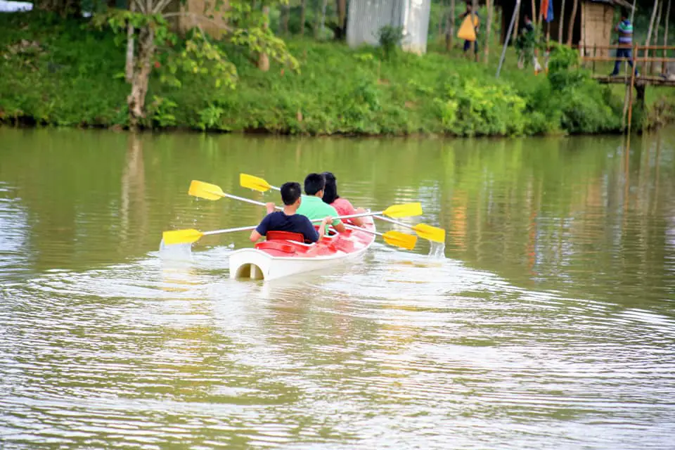 Three tourist are boating in the best travel destination in Bangladesh, Mayabini Lake, Khagrachari