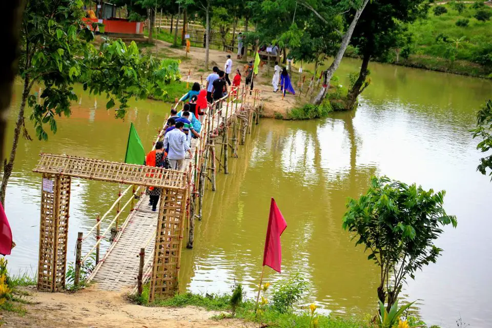 Mayabini Lake visitors are passing lake through a bamboo bridge