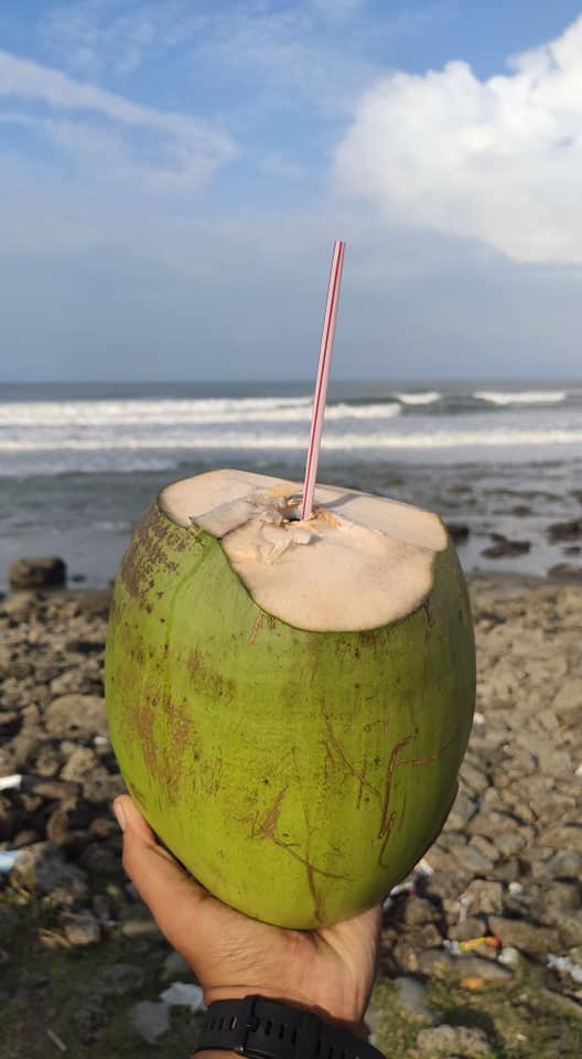 Drink coconut water in Cox's Bazar the longest sea beach in the world. Drink coconut water with a straw in Cox's Bazar.