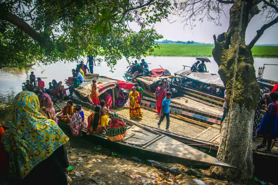 Lots of women and children are in Haltir Beel in Natore. There are also quite a few boats near the beel.