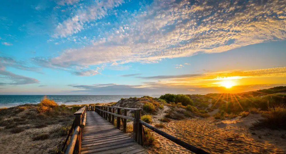 It is a plank path that leads to the beach, in a magical sunset at Huelva, Spain