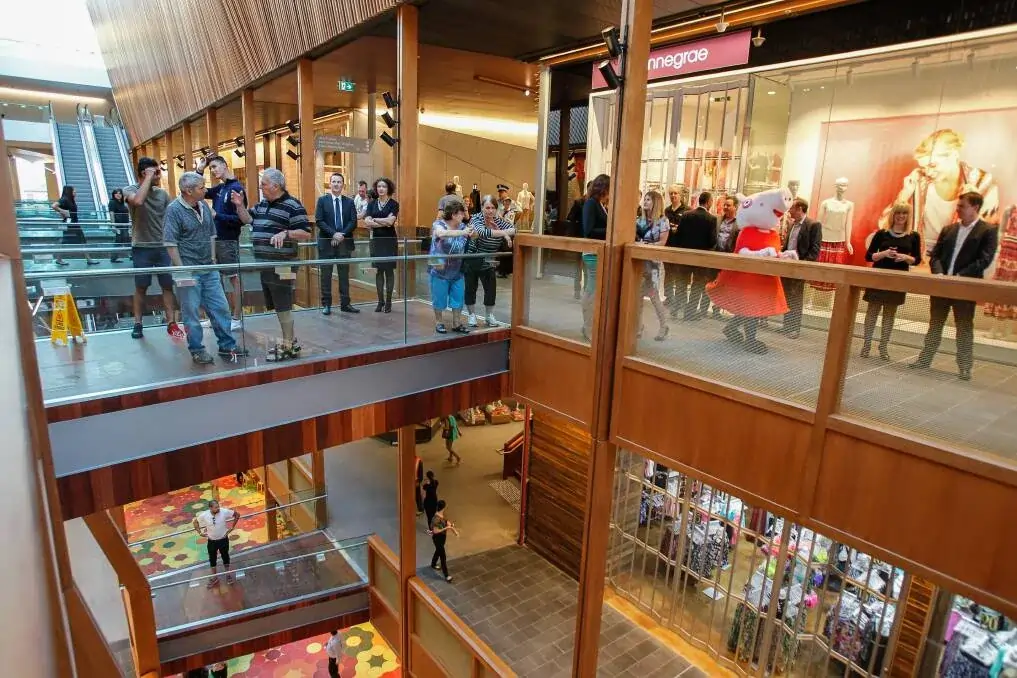 People walking through a crowded mall.