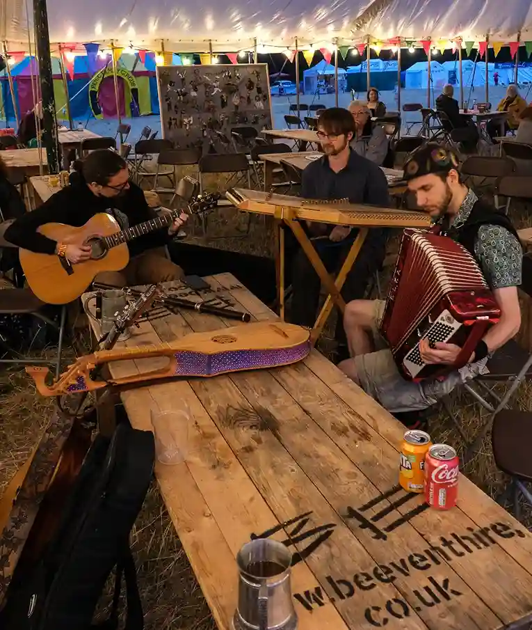 a diverse group of people playing instruments at a table