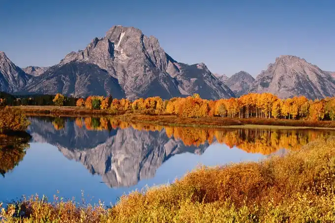a mountain range reflected in a lake