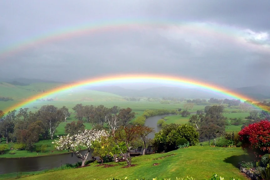 a rainbow over a river